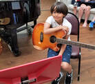 Boy holding guitar, guitar lessons virginia beach